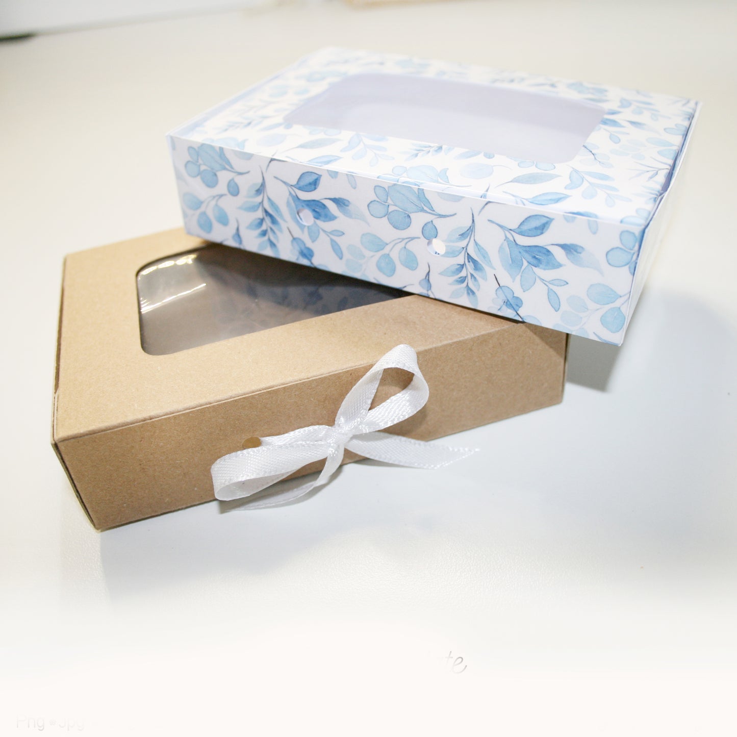 Gift box with floral patterned lid and brown base on a white background