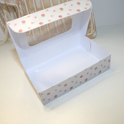 White box with pink polka dot pattern on a light background