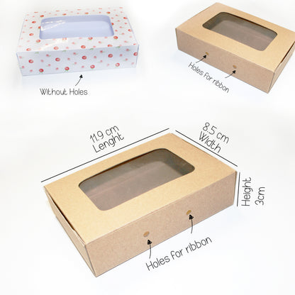 Two cardboard boxes with windowed design, one without holes and one with holes for ribbon, on a white background.