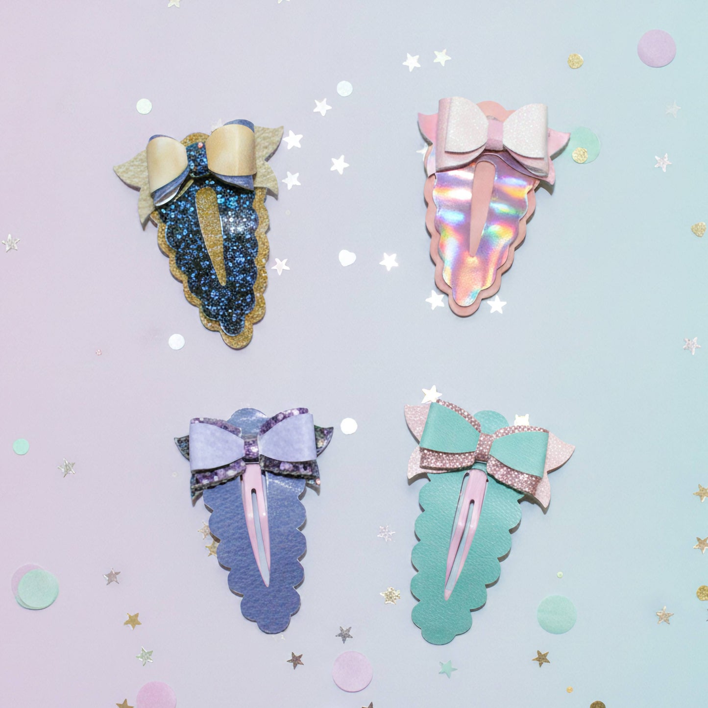 Four unicorn horn hair clips on a pastel background with scattered star and circle confetti. The clips feature glittery and iridescent unicorn horns with matching bows in pastel shades of blue, gold, pink, purple, and mint green.