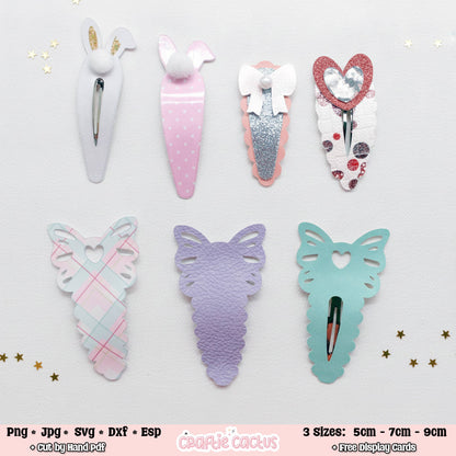 Six decorative hair claw clips arranged in two rows on a white background with small gold star confetti. The top row includes bunny-ear clips in white and pastel pink, a glittery silver bow clip, and a red glitter heart clip.