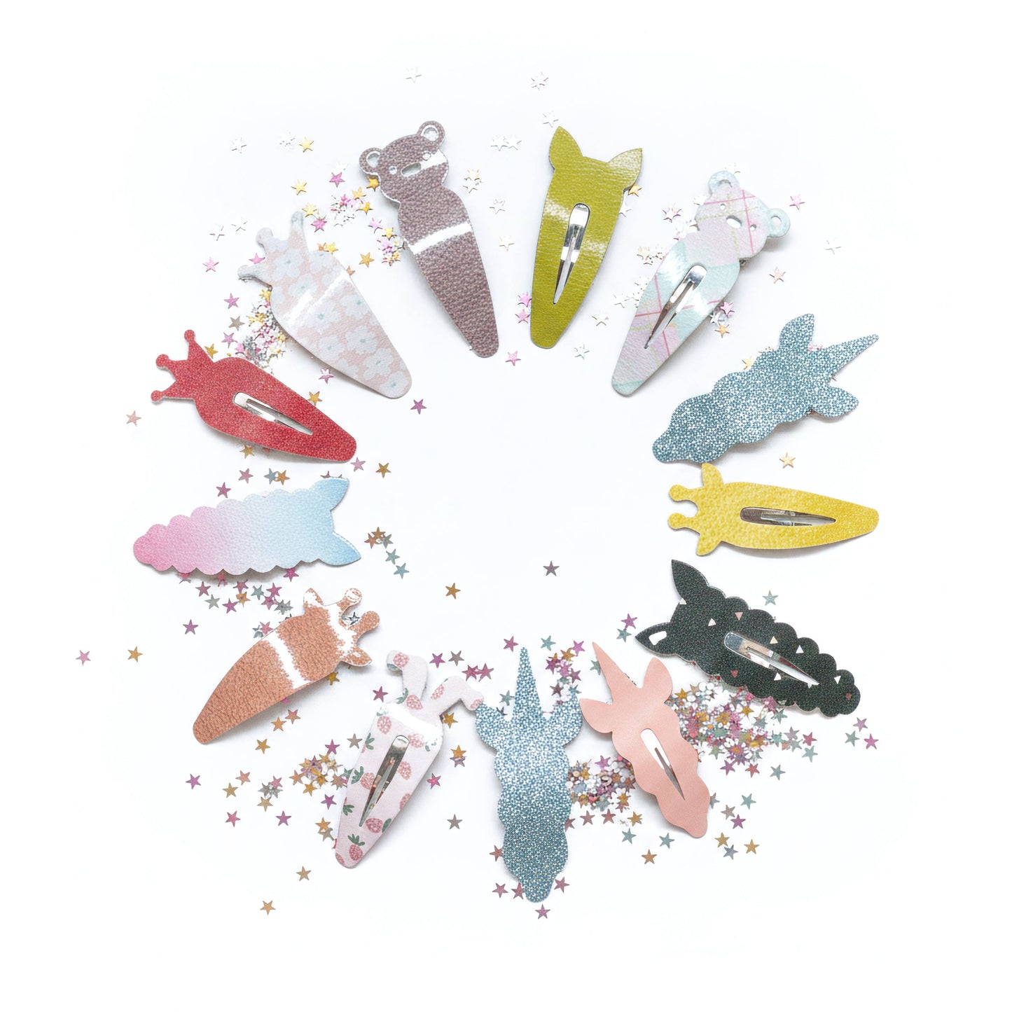 A set of glittery hair clips shaped like animals and nature elements, arranged in a circle on a white background with scattered star confetti. The clips include a bear, rabbit, duck, fish, turtle, unicorn, and other shapes in various pastel and metallic colors.