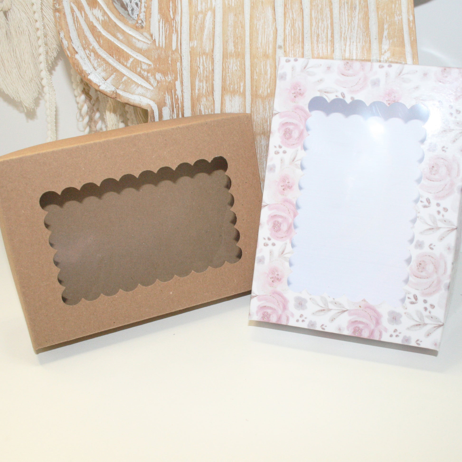 Kraft paper box with window and floral-patterned paper on a wooden surface