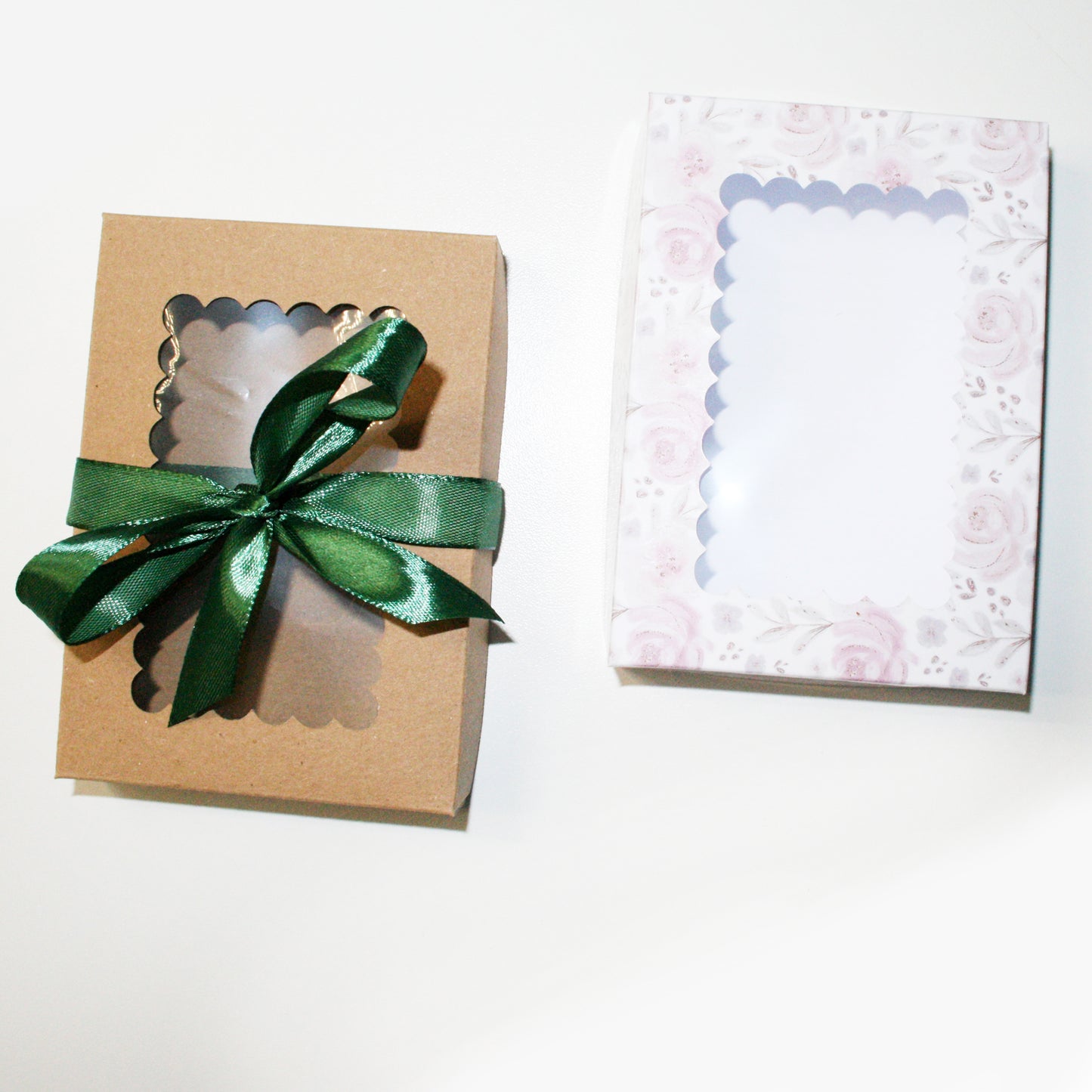Gift box with a green ribbon and a decorative card on a white background