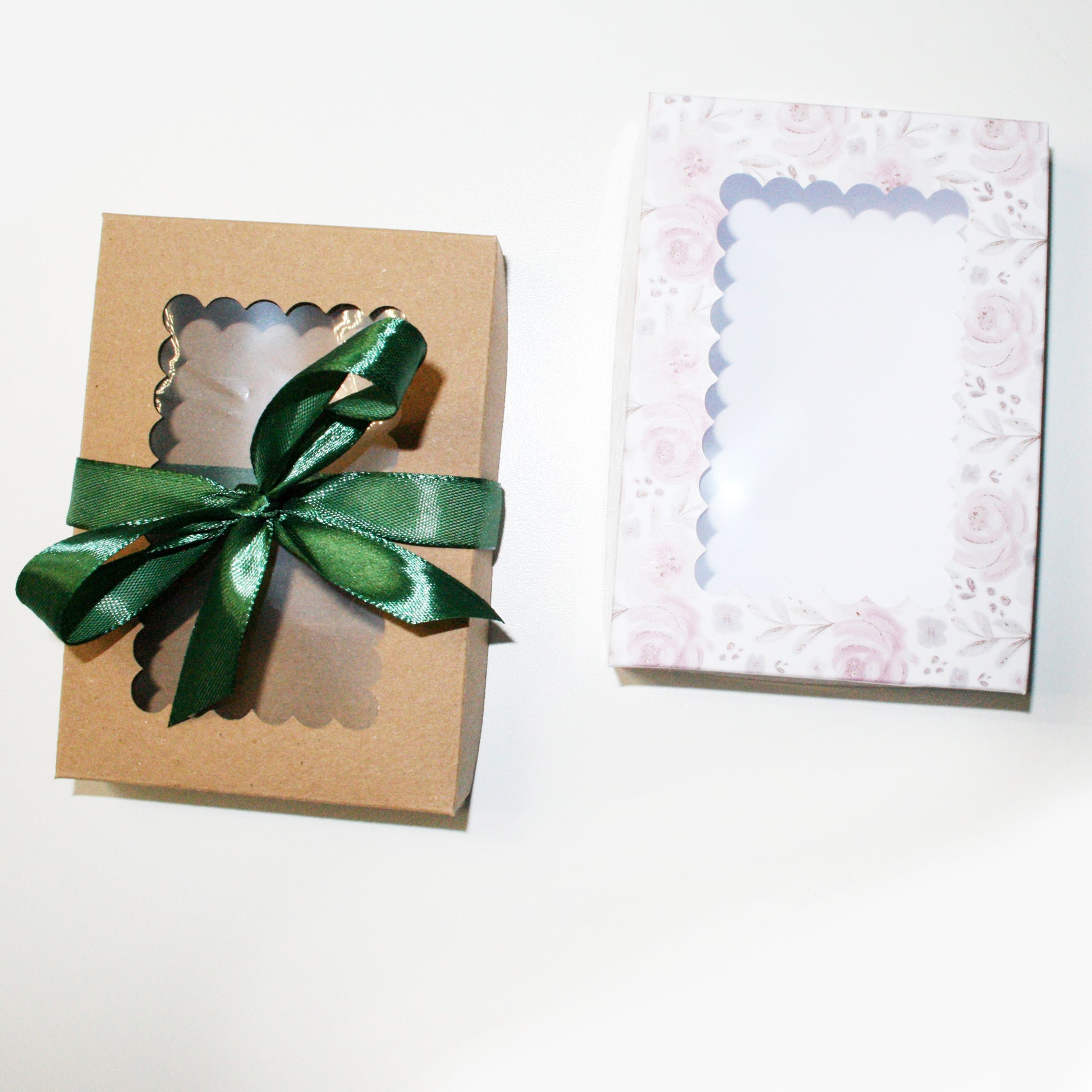 Gift box with a green ribbon and a decorative card on a white background