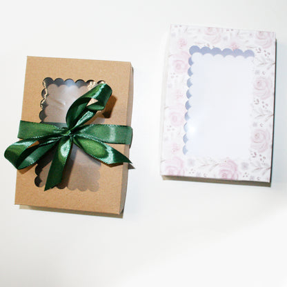 Gift box with a green ribbon and a decorative card on a white background