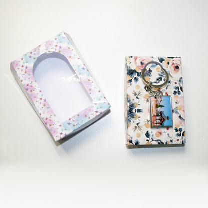 Two decorative boxes with floral patterns on a white background