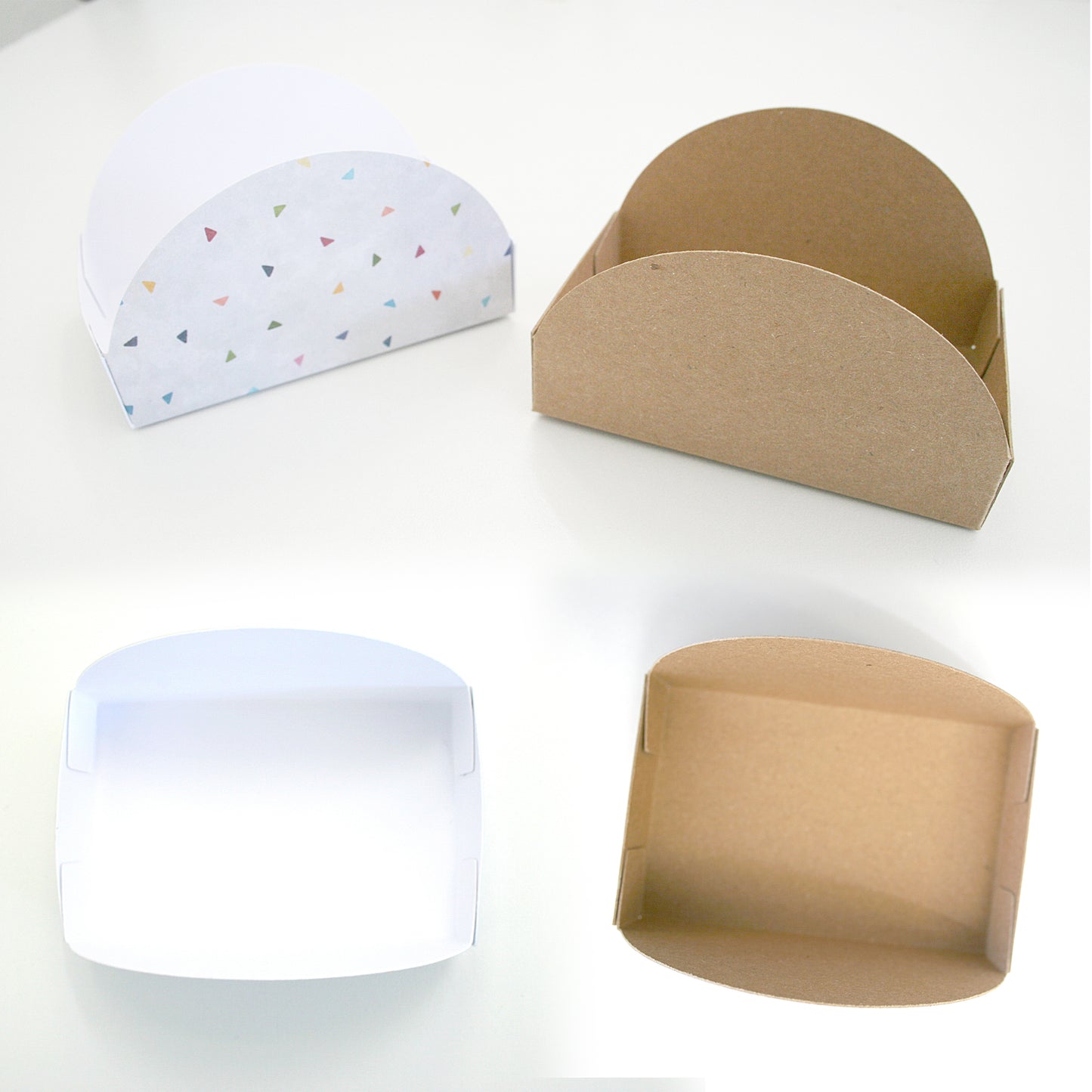 Four cardboard boxes in different colors on a white background