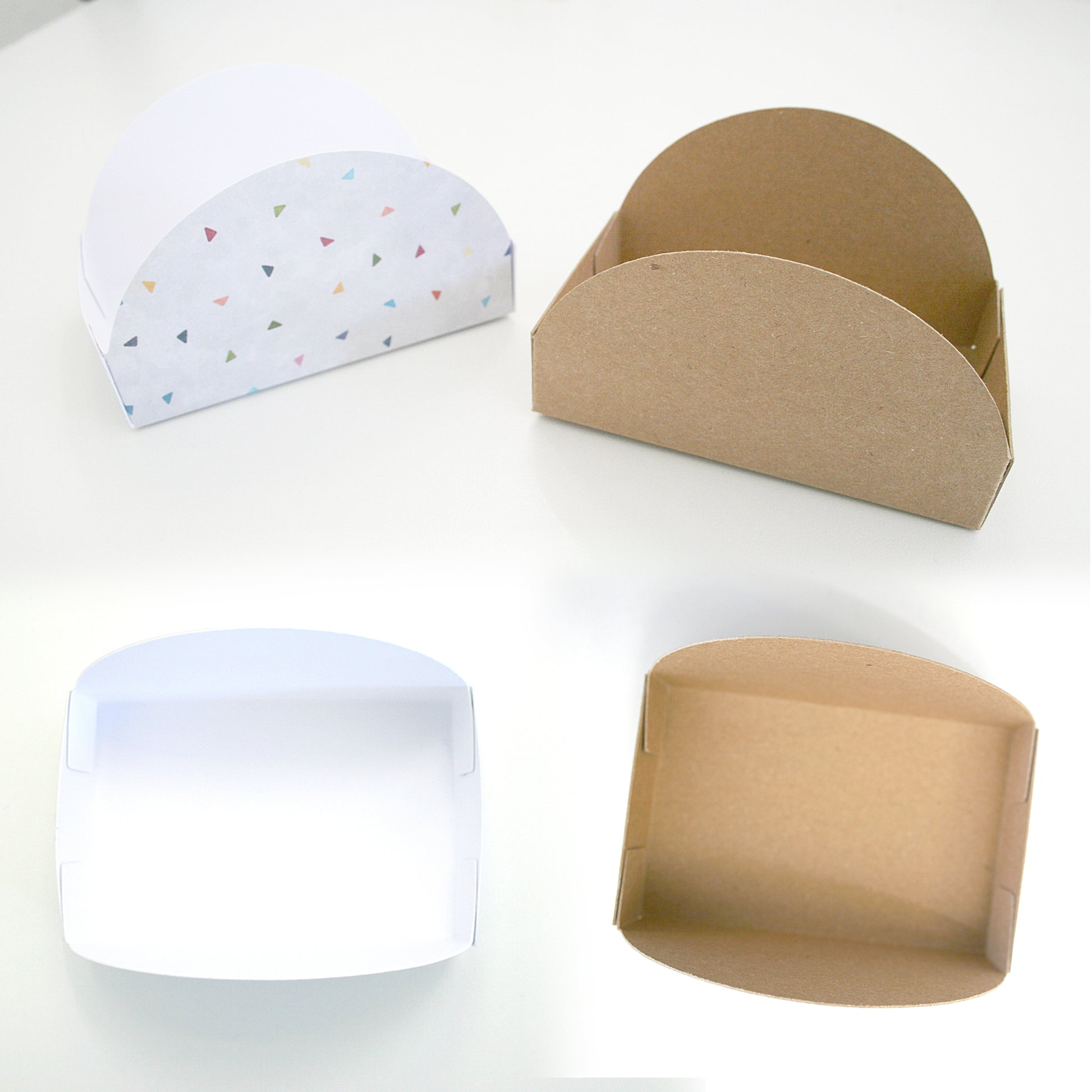 Four cardboard boxes in different colors on a white background